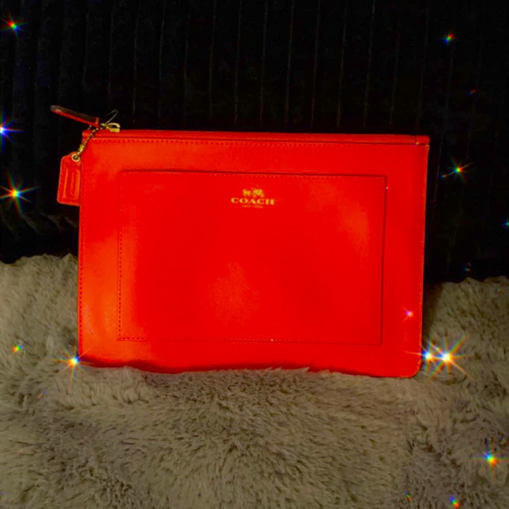 Coach  orange leather clutch doesn’t have tag but brand new never been used